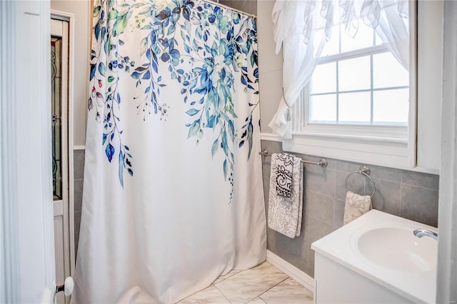 bathroom with tile walls and vanity