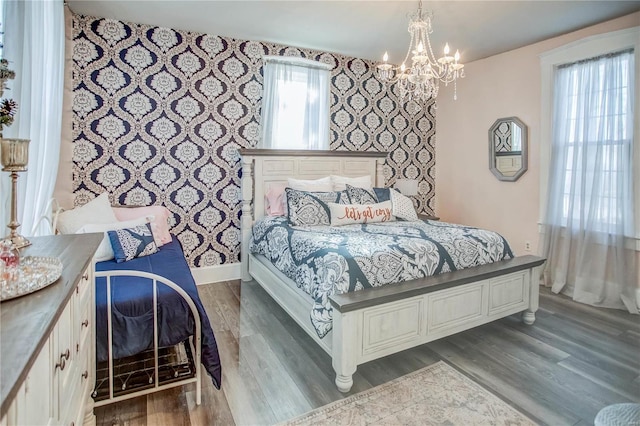 bedroom with a notable chandelier and dark hardwood / wood-style flooring