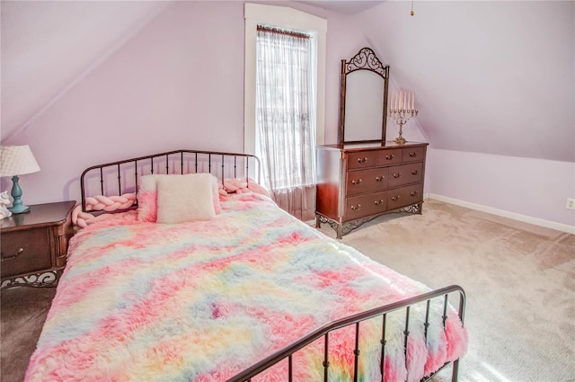 bedroom with vaulted ceiling and carpet flooring