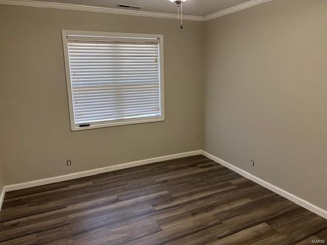 unfurnished room featuring dark wood-type flooring and crown molding