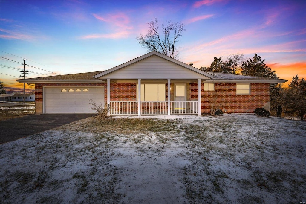 single story home with a garage and covered porch