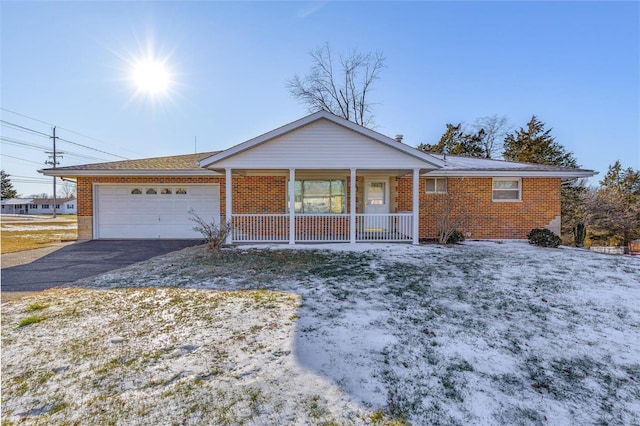 single story home featuring a porch and a garage