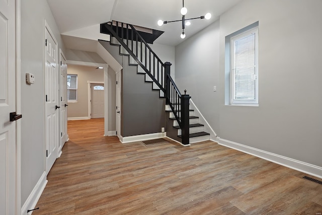 stairs featuring hardwood / wood-style flooring