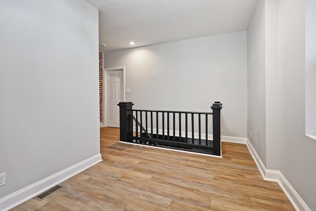 hallway with light hardwood / wood-style flooring