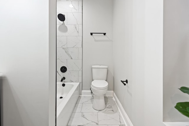 bathroom featuring tiled shower / bath combo and toilet