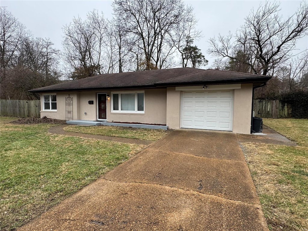 ranch-style house with a garage and a front lawn