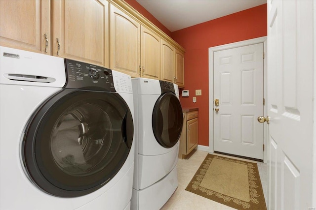 laundry area featuring cabinets, separate washer and dryer, and light tile patterned floors