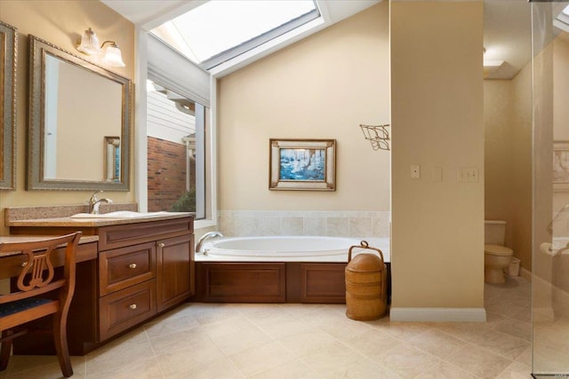 bathroom featuring vanity, a washtub, tile patterned floors, and toilet