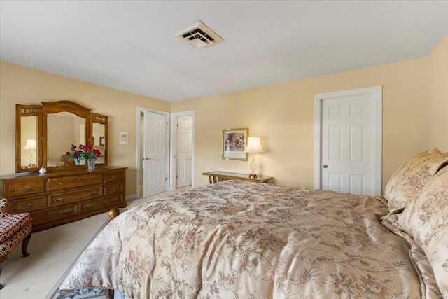 bedroom with multiple closets and carpet floors