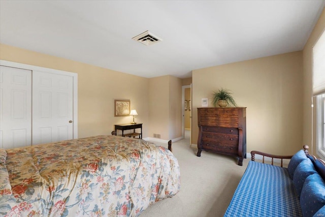 bedroom with light colored carpet and a closet