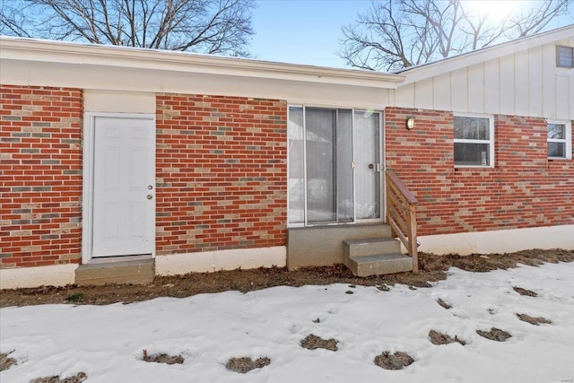 view of snow covered property entrance