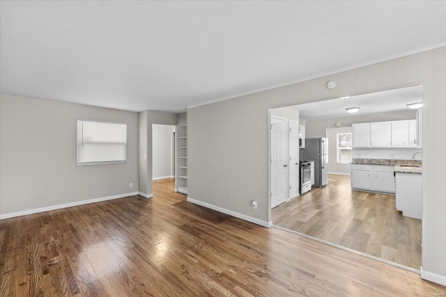 unfurnished living room with hardwood / wood-style floors