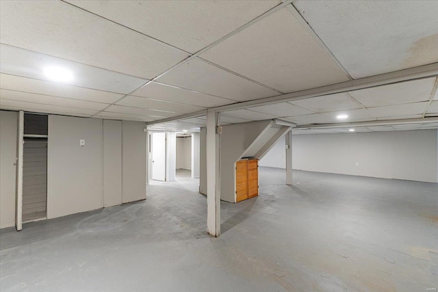 basement with a paneled ceiling