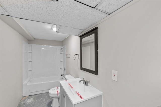 full bathroom with concrete floors, vanity, toilet, tub / shower combination, and a drop ceiling