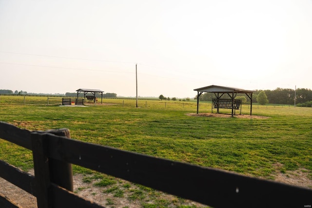 view of property's community featuring a rural view and a lawn