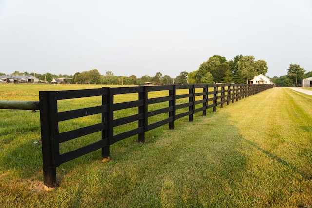 view of gate featuring a rural view and a yard