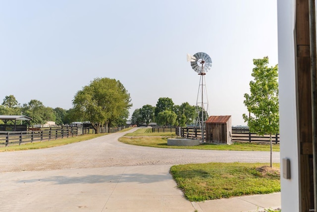 view of home's community with a rural view and an outdoor structure