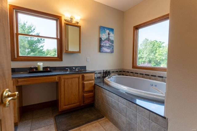 bathroom featuring vanity, tile patterned floors, and tiled tub