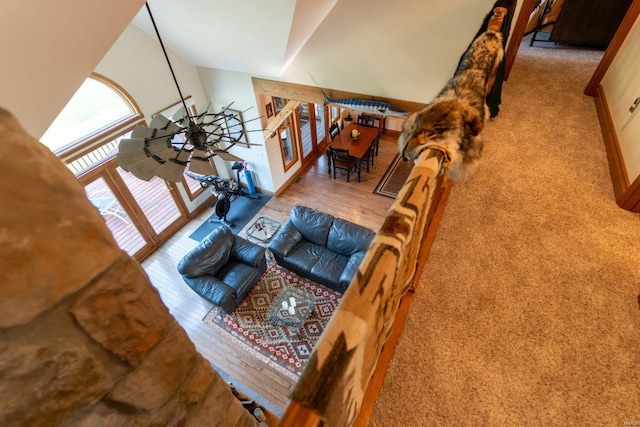 living room featuring lofted ceiling and light hardwood / wood-style flooring