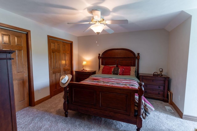 bedroom with ceiling fan, a closet, and light colored carpet