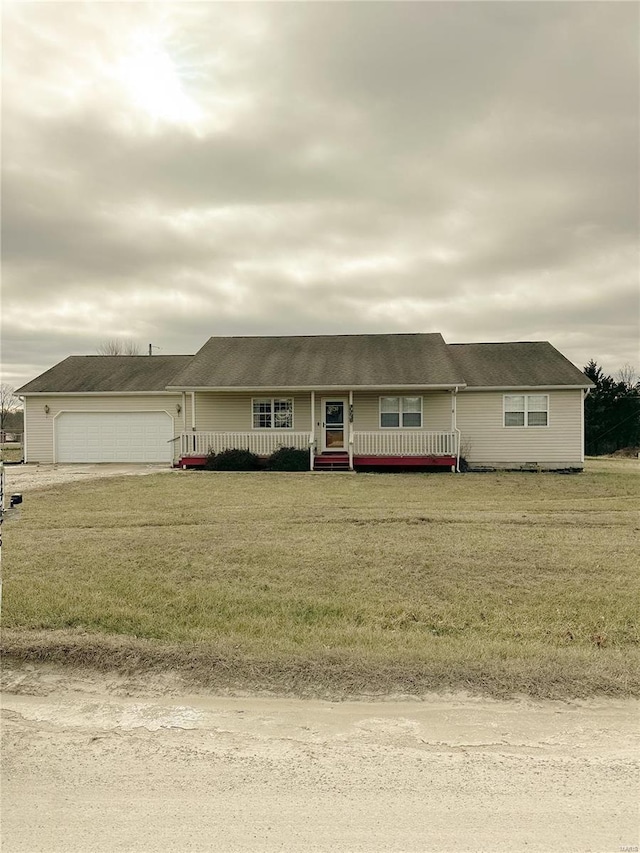 view of front of property featuring a porch, a garage, and a front yard