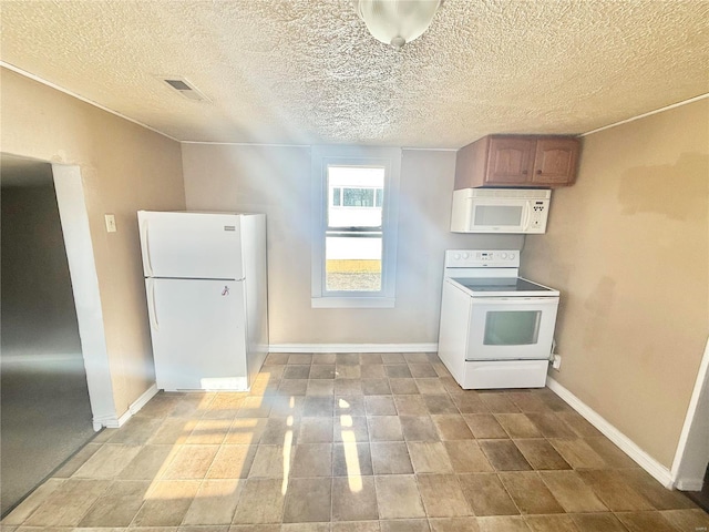 kitchen with white appliances and a textured ceiling