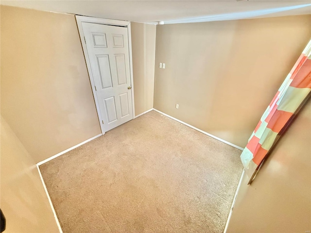 unfurnished room featuring carpet