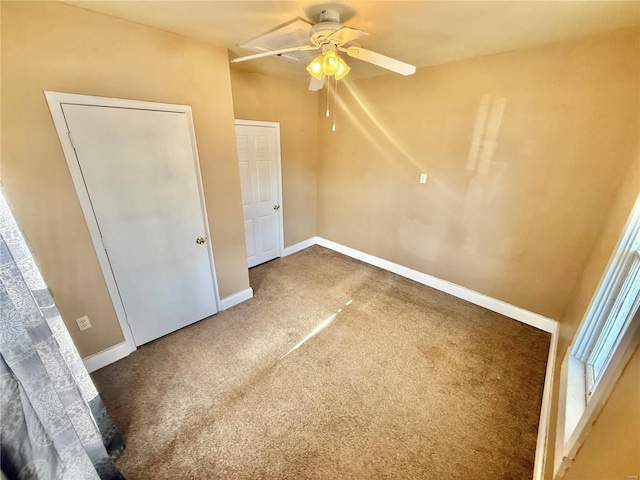 unfurnished bedroom featuring ceiling fan, dark carpet, and a closet