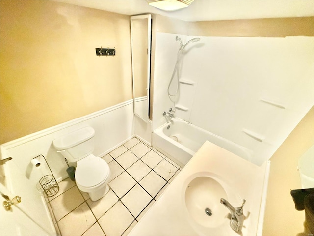 full bathroom featuring toilet, sink, tile patterned floors, and shower / washtub combination