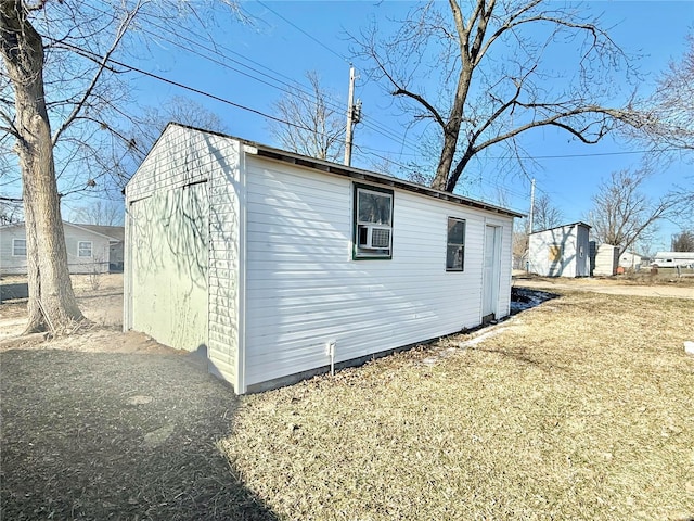 view of property exterior featuring an outbuilding and a yard