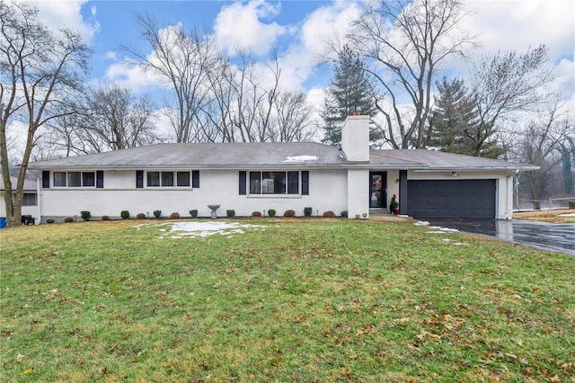 ranch-style home with a garage and a front lawn