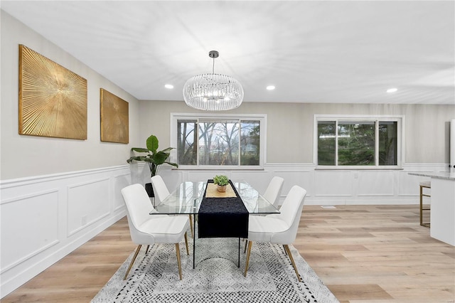 dining room featuring a notable chandelier and light hardwood / wood-style floors