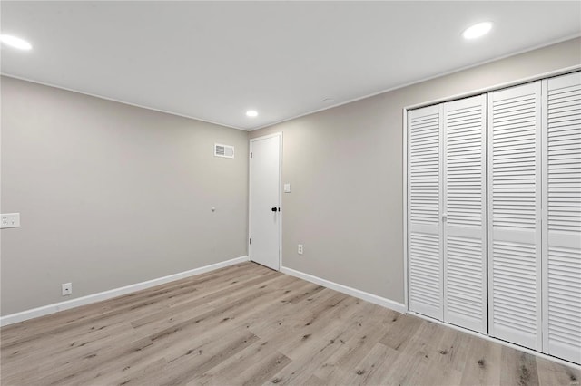 interior space with light hardwood / wood-style floors and a closet