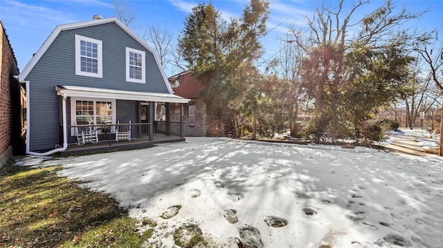 snow covered property featuring a porch