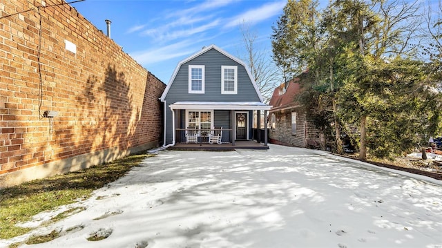 rear view of property with a porch