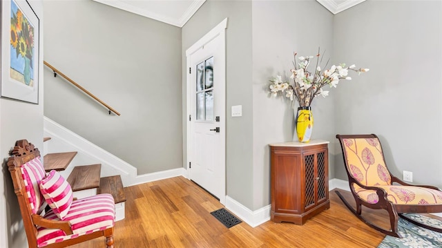 entrance foyer featuring light hardwood / wood-style floors and ornamental molding