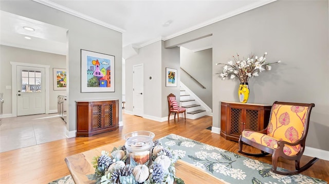 living room with light hardwood / wood-style flooring and ornamental molding