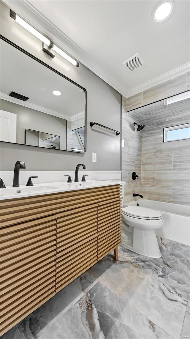 full bathroom with toilet, tiled shower / bath combo, vanity, and crown molding