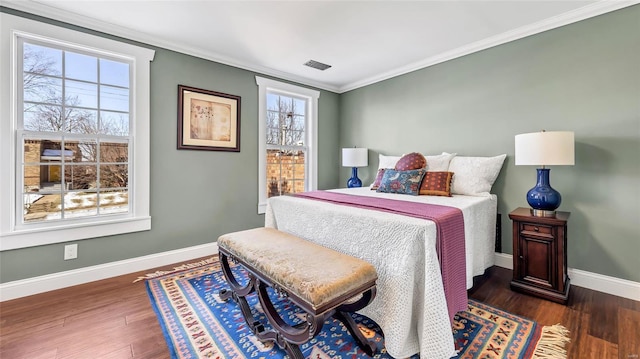 bedroom with crown molding and dark hardwood / wood-style floors