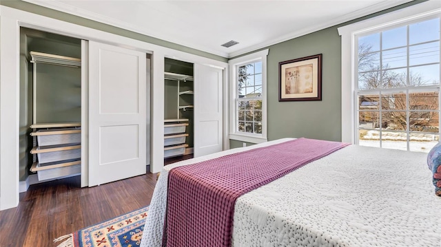 bedroom with multiple windows, dark hardwood / wood-style floors, and crown molding