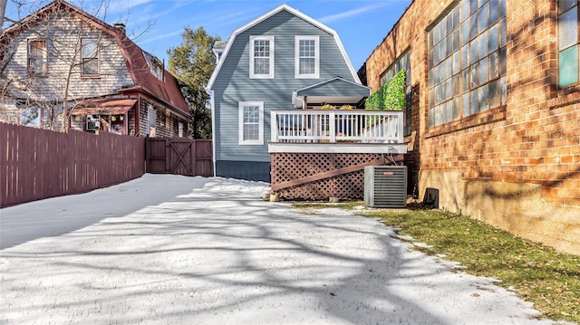 back of house featuring a wooden deck and central AC