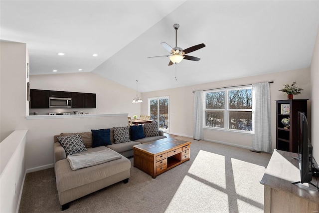 carpeted living room with ceiling fan and lofted ceiling