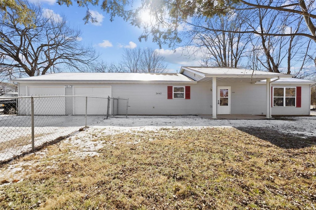 back of house featuring a garage