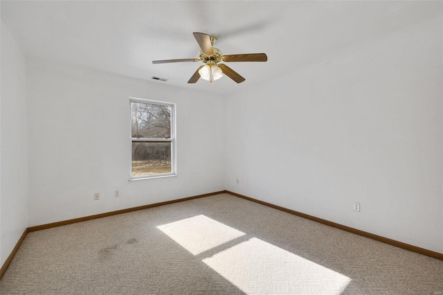 spare room with ceiling fan and carpet