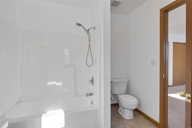 bathroom with tub / shower combination, toilet, and tile patterned flooring