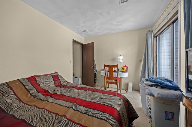 carpeted bedroom featuring multiple windows