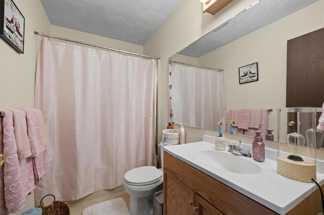 bathroom with vanity, toilet, and tile patterned flooring