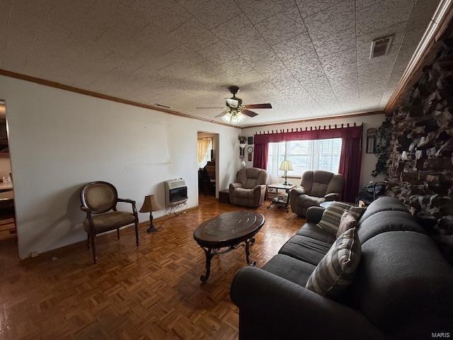 living room with heating unit, parquet floors, ceiling fan, and ornamental molding