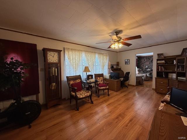 living area featuring ceiling fan and wood-type flooring