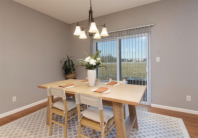 dining space featuring a chandelier and hardwood / wood-style floors